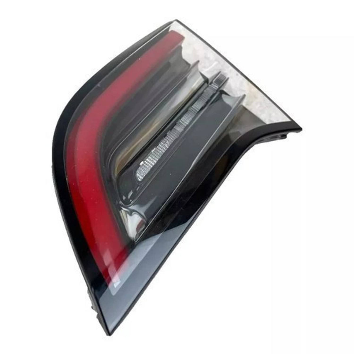 Right inner tail light with red lens and clear cover, dark base and internal ribs.