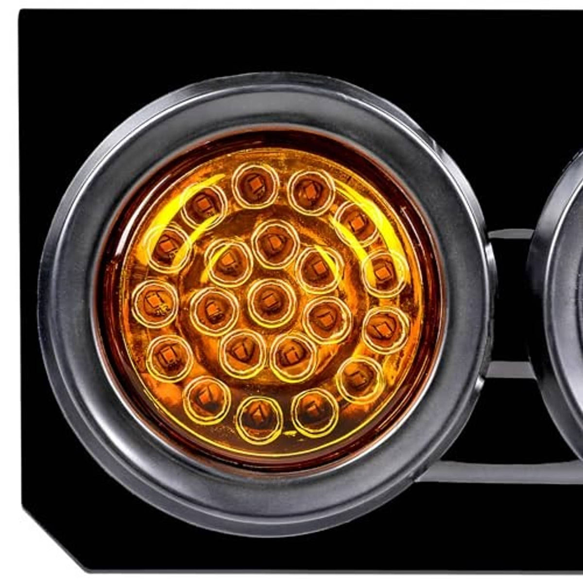 Round amber LED lens on a truck trailer tail light housing
