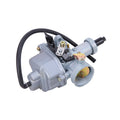 Light gray motorcycle carburetor with black hoses and metal fuel fittings