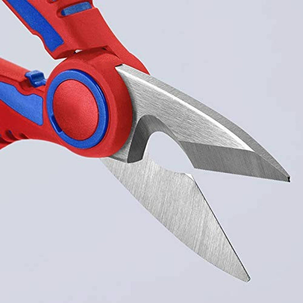 Close-up of electricians' shears cutting blades and pivot, red handle with blue accents