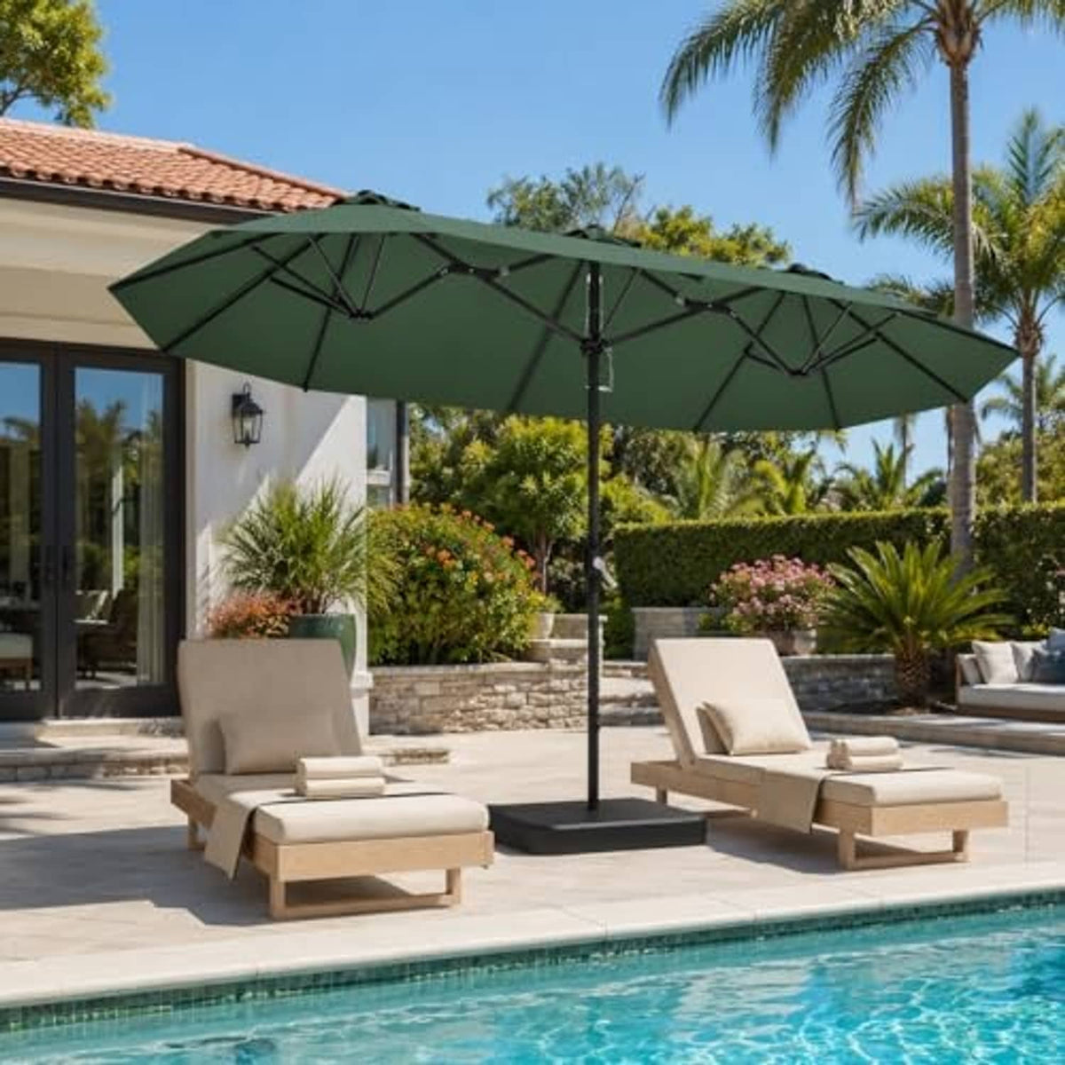 Dark green patio umbrella open over pool patio with metal stand and crank pole