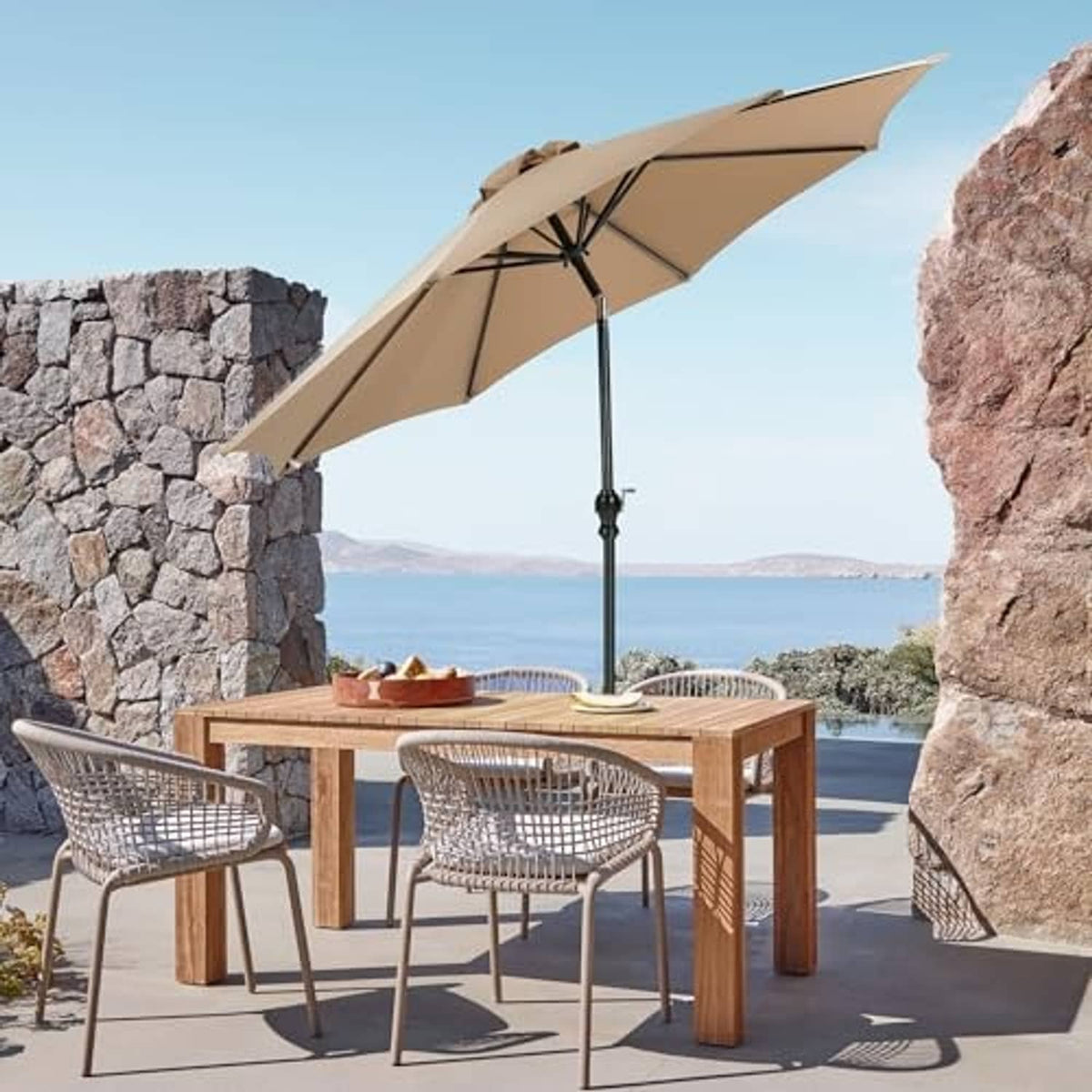 Tan patio umbrella open over outdoor dining table