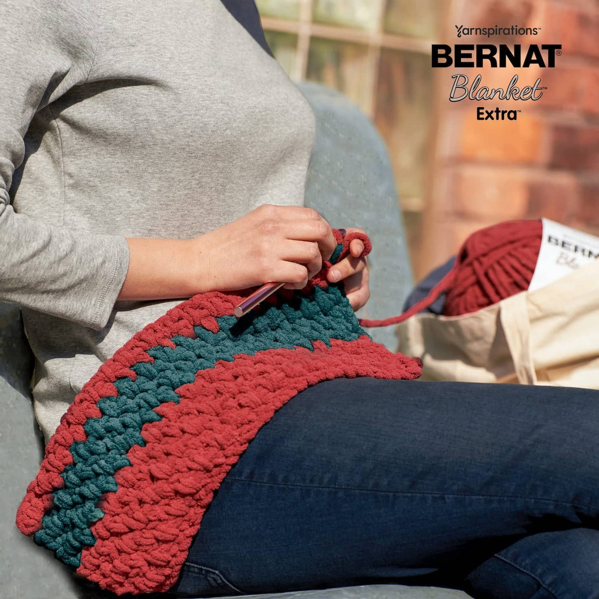 Red and teal chunky knit chenille-style blanket swatch, soft polyester yarn