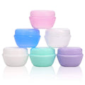 Set of 1 oz plastic toiletry jars with pastel lids, stacked in a group