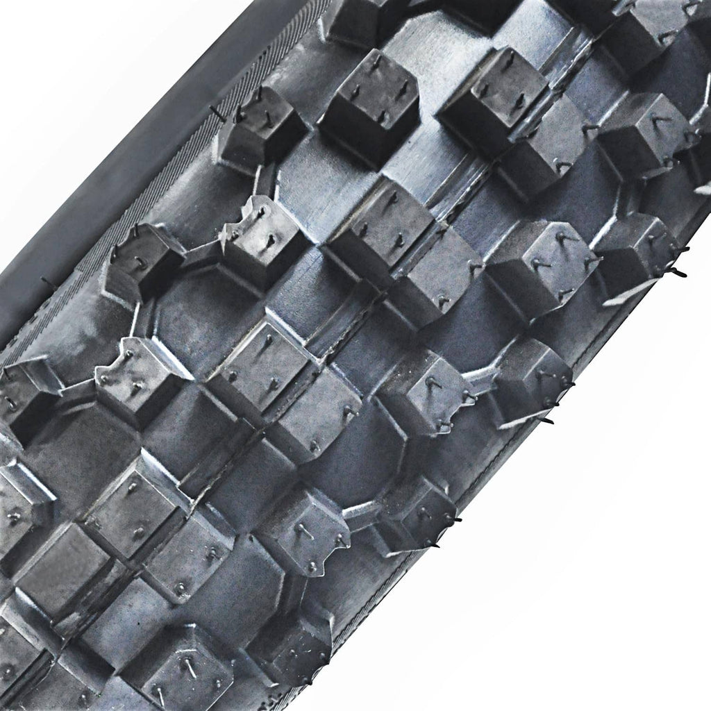 Close-up of knobby motorcycle tire tread blocks