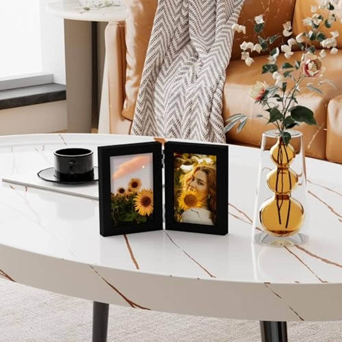 Black double photo frame with two standing panels, showing portrait photos