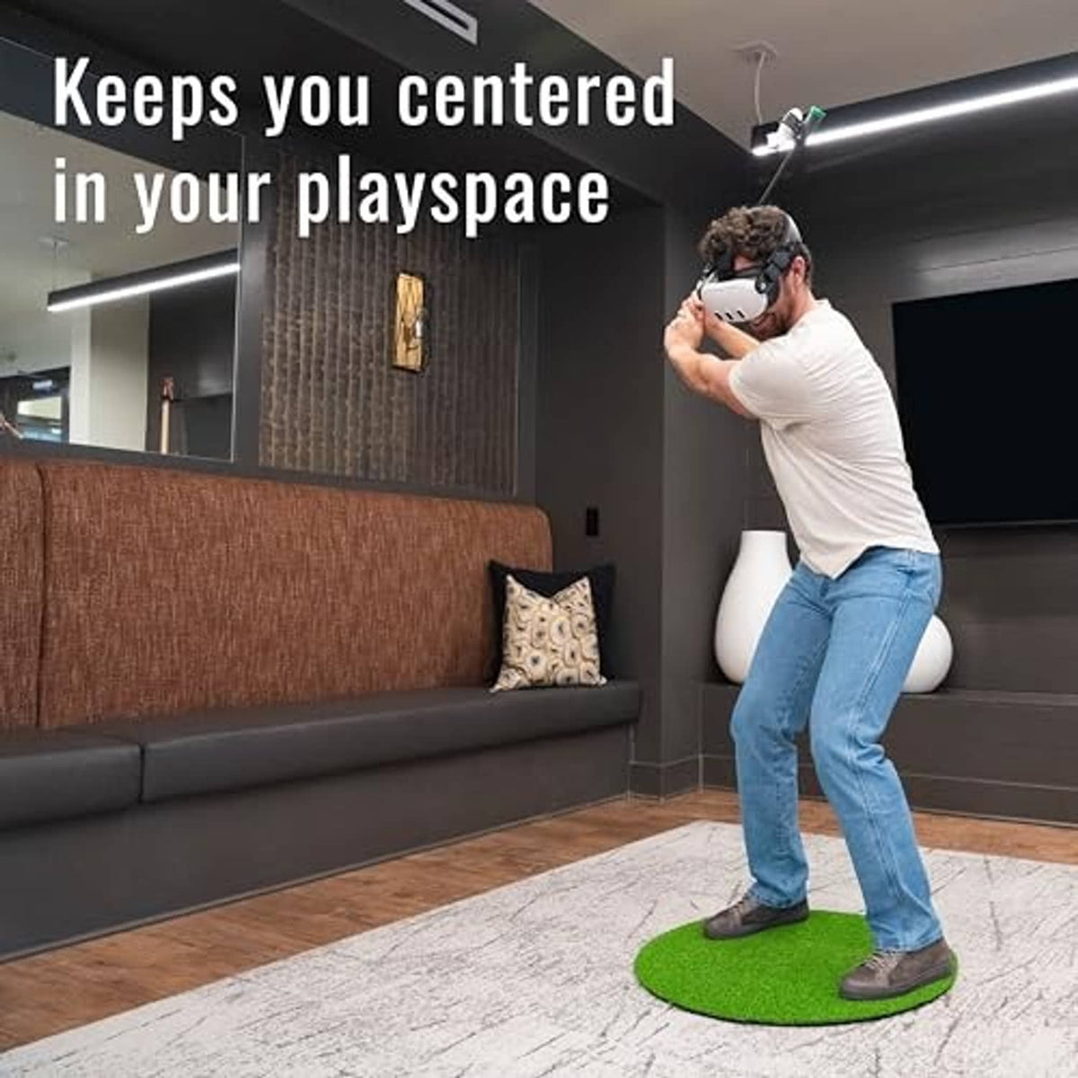 Round green synthetic grass VR practice mat on floor, player stance and controller visible