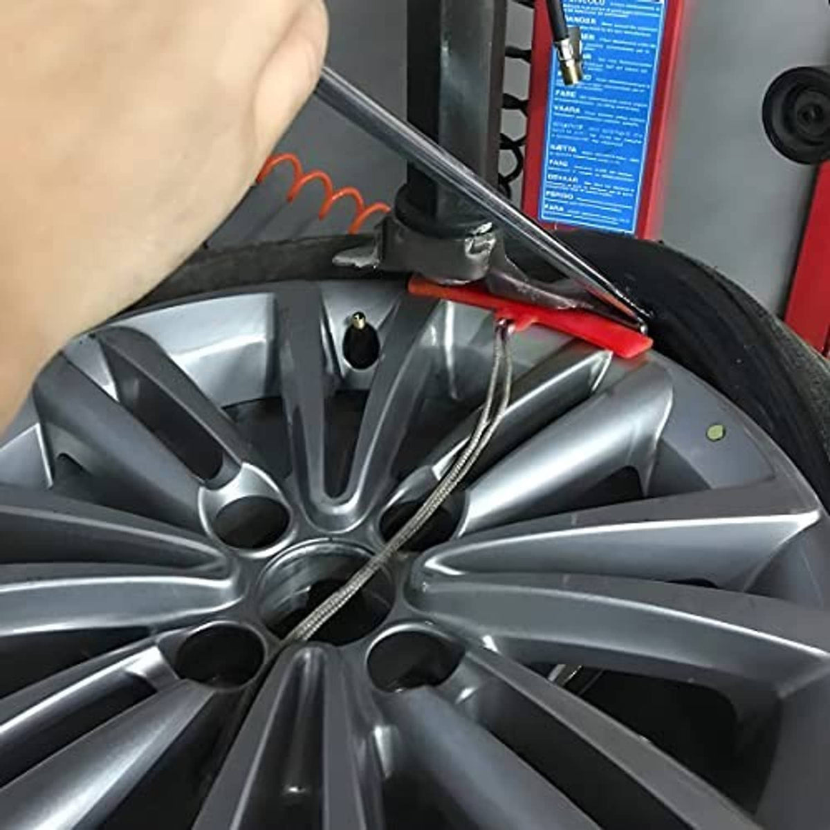 Red rim saver strip on a car wheel rim during tire changing