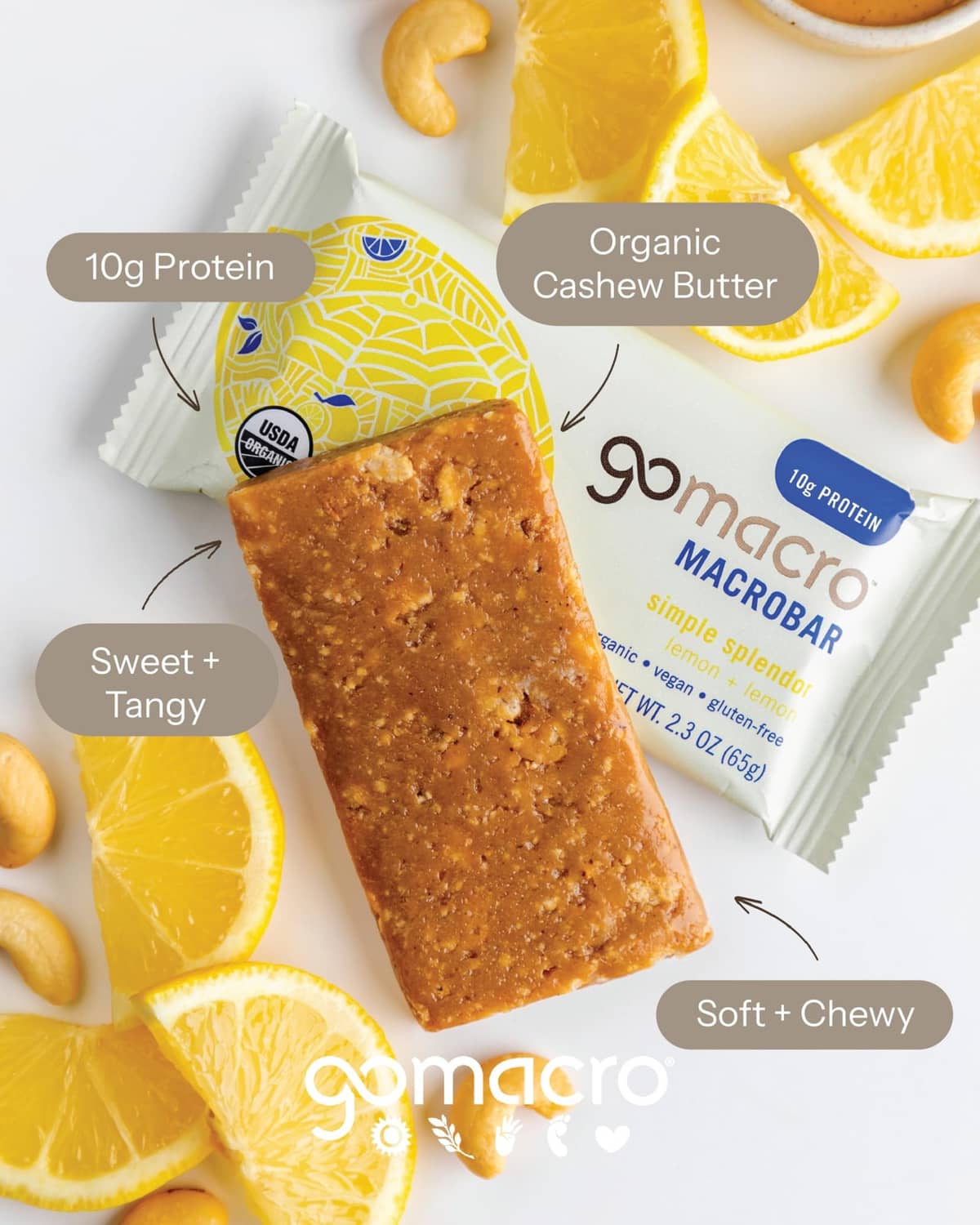 Organic lemon protein bar with cashews and lemon slices around the wrapped bar