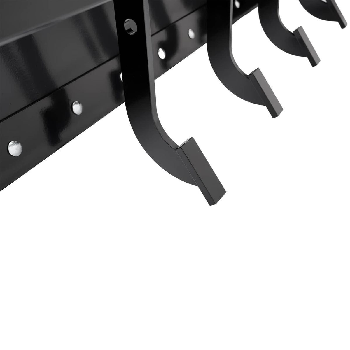 Close-up of black curved scraper blades and mounting plates on tow-behind box scraper