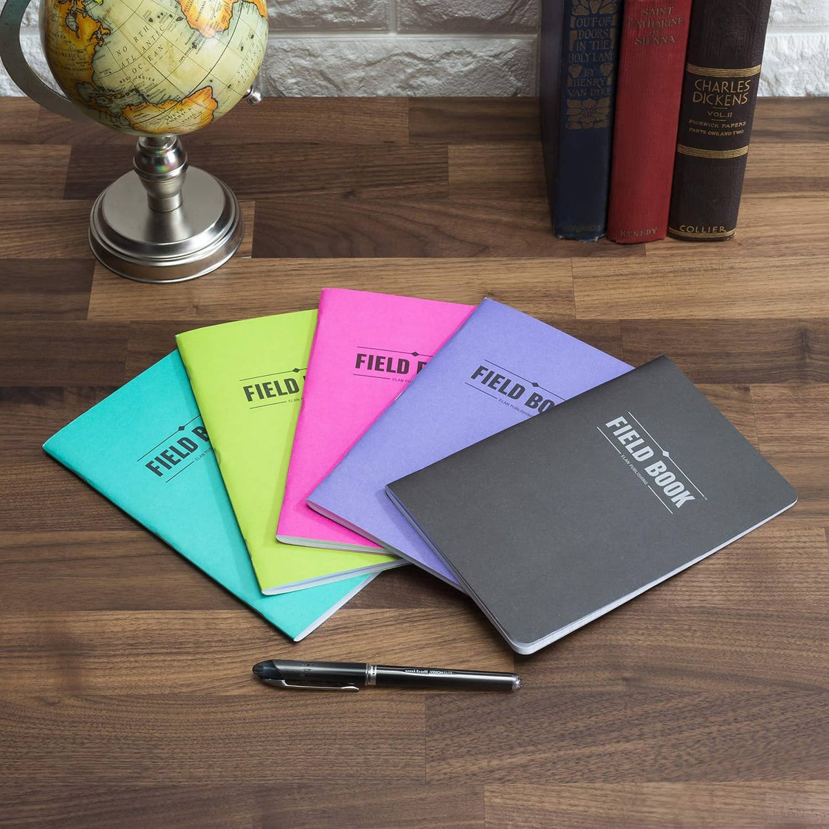 Assorted lined Field Book notebooks with logos in teal, lime, pink, lavender, and gray