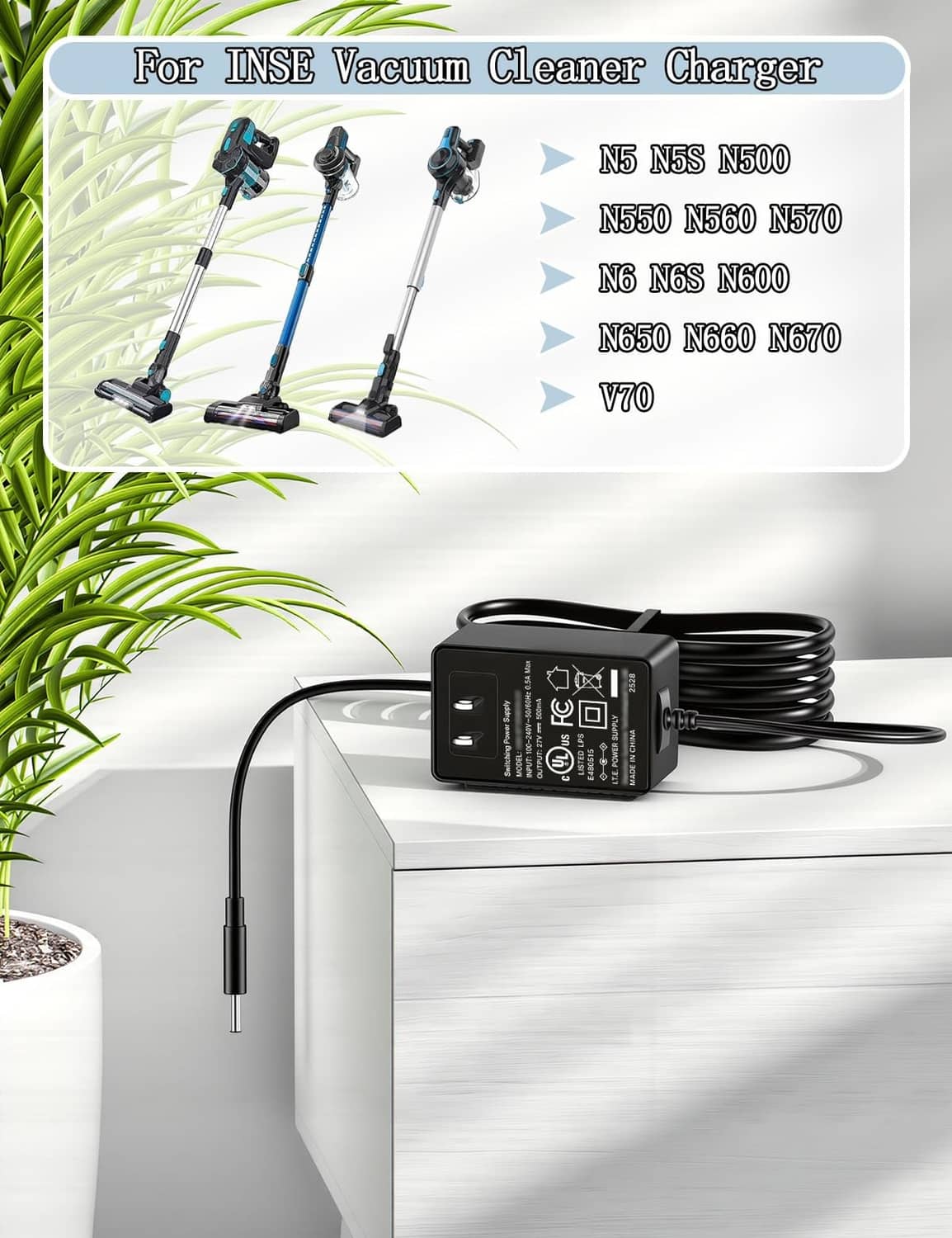 Black vacuum charger adapter with coiled cable on tabletop