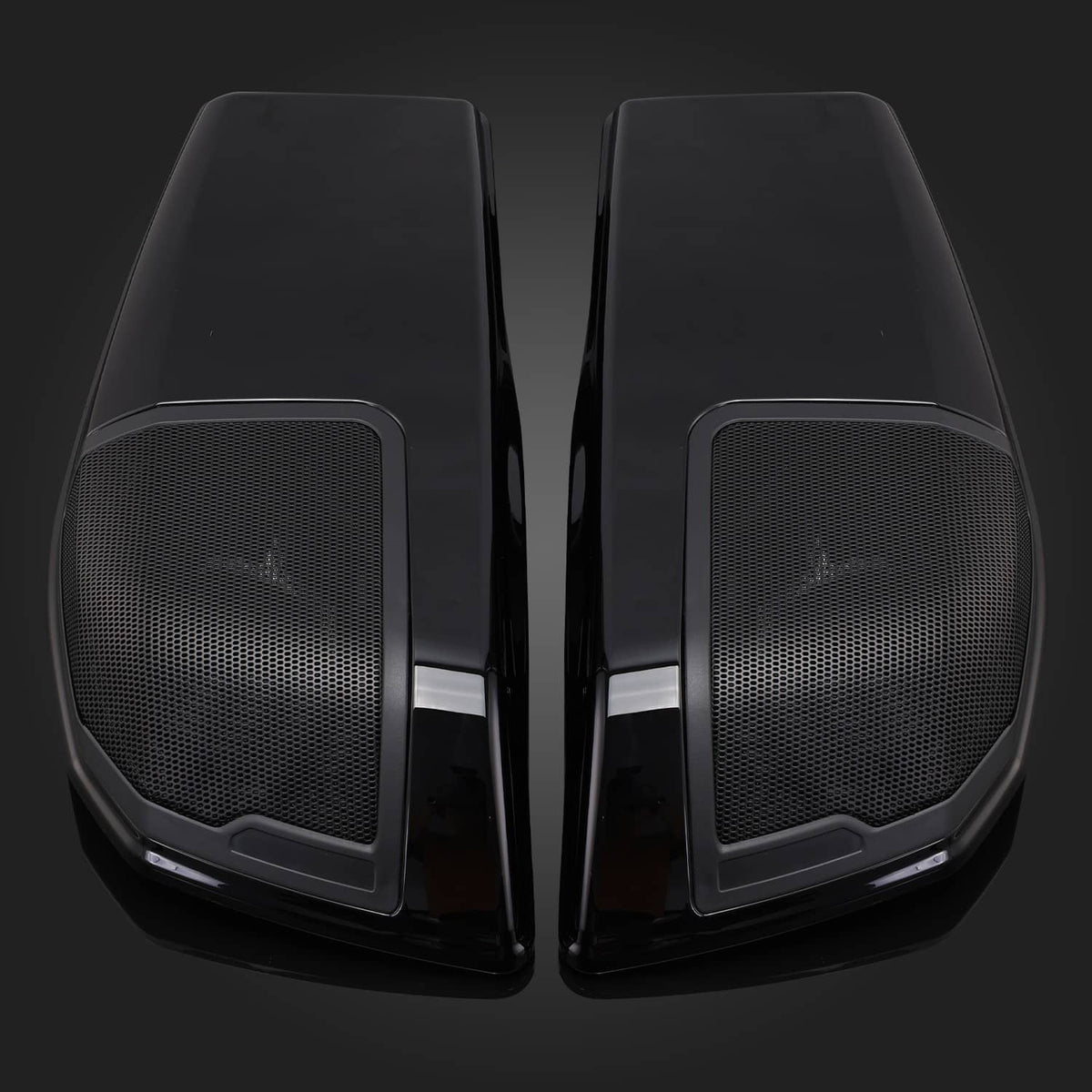 Close-up of two black saddlebag speaker lids with mesh grille panels
