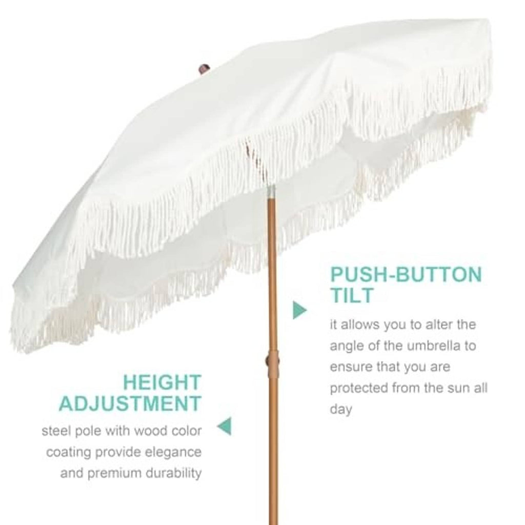 Outdoor patio umbrella with white fringe trim and wooden center pole, angled view.
