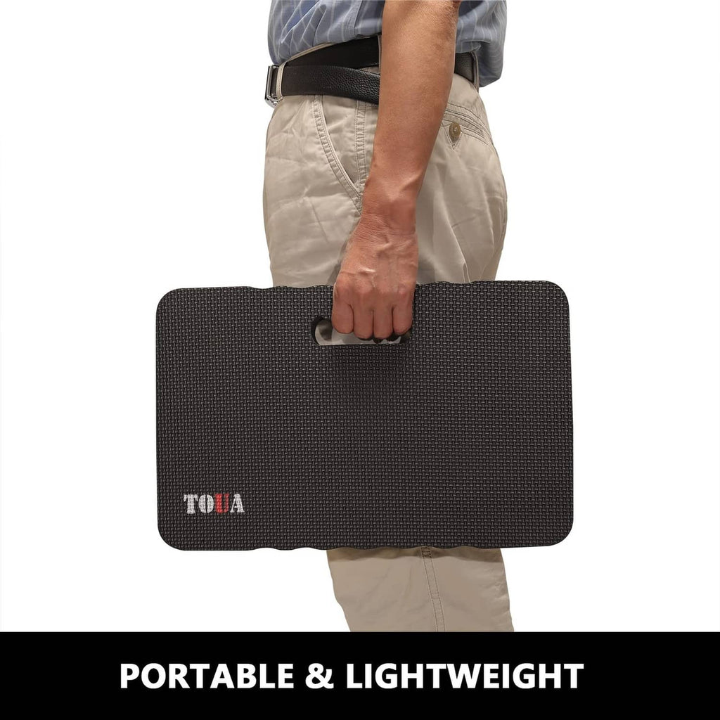 Large dark gray kneeling pad with carry handle, shown being held for portability.