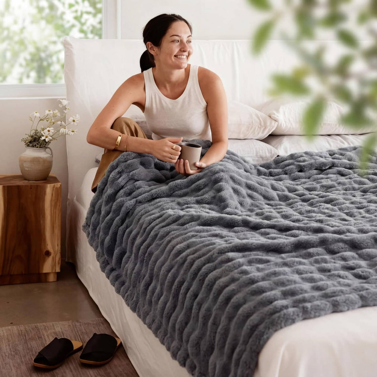 Gray bubble fleece blanket on a bed, thick plush 3D bubble texture