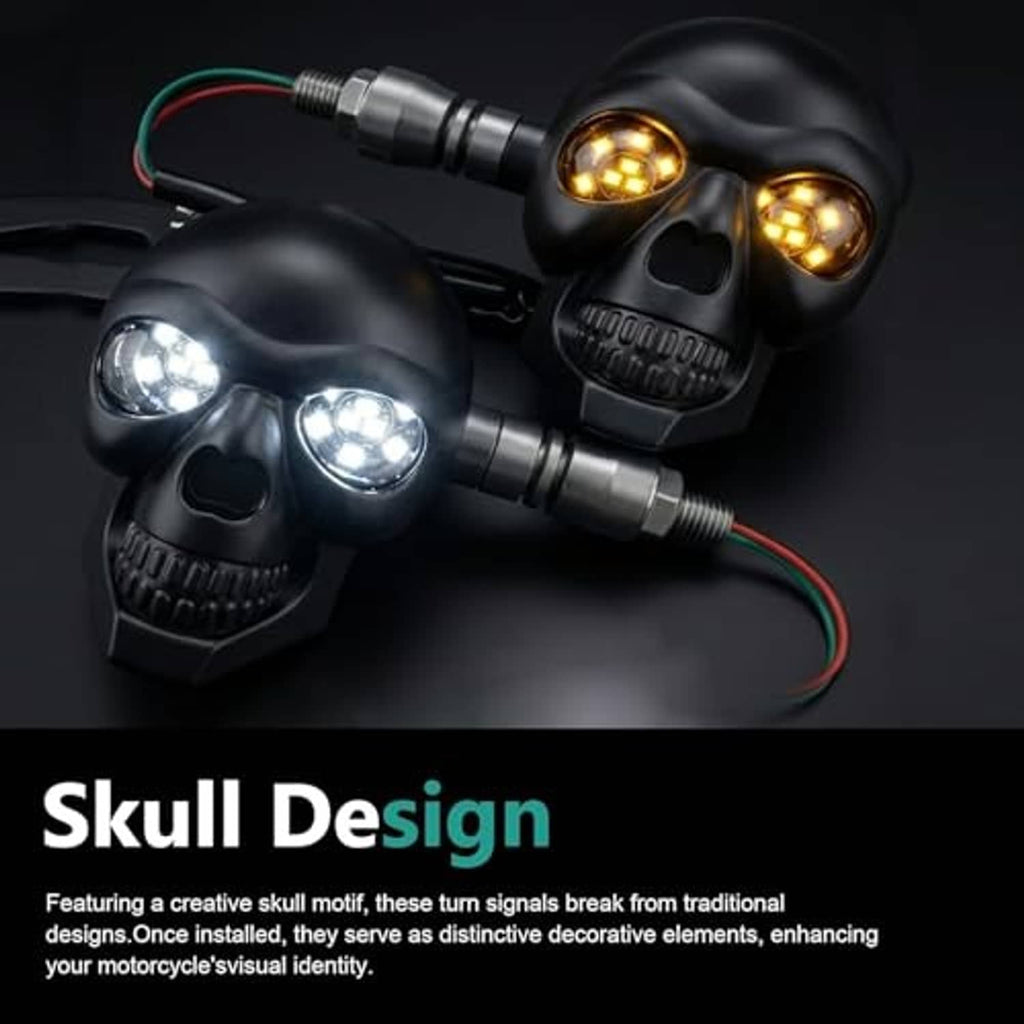 Black skull motorcycle LED turn signal lights with amber glowing lenses and red-green wiring
