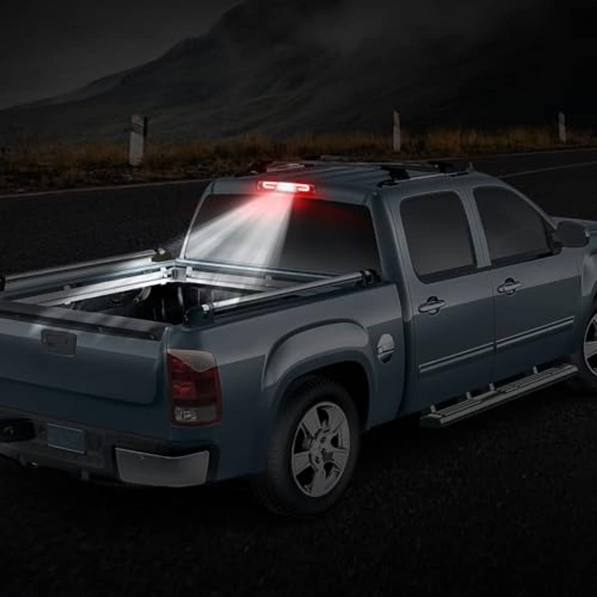Installed smoked-lens LED third brake light on a pickup truck, red brake glow