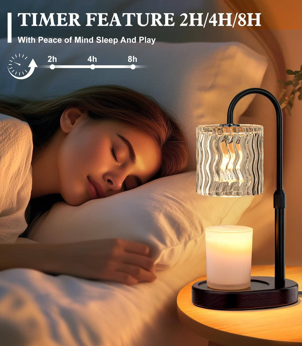 Electric candle warmer lamp with clear wavy glass shade and lit candle on bedside table