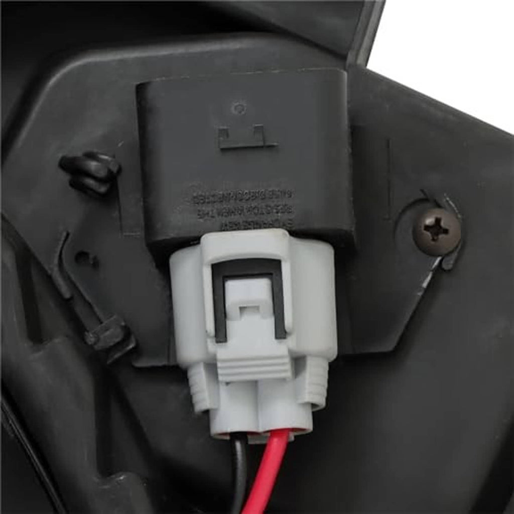 Radiator cooling fan electrical connector close-up with red wire on black housing