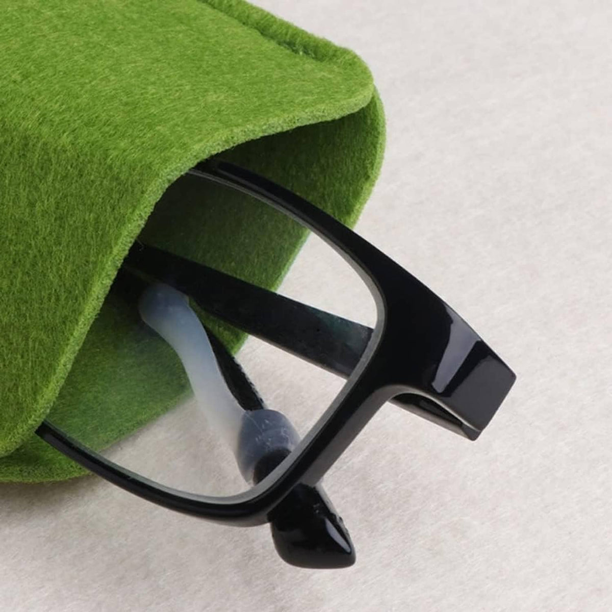 Green felt eyeglass slip-in pouch holding a pair of black-framed glasses
