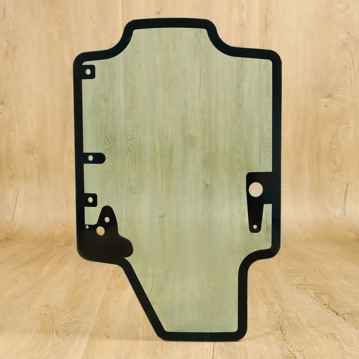 Skid steer door glass panel with black metal frame and mounting brackets, tinted light green