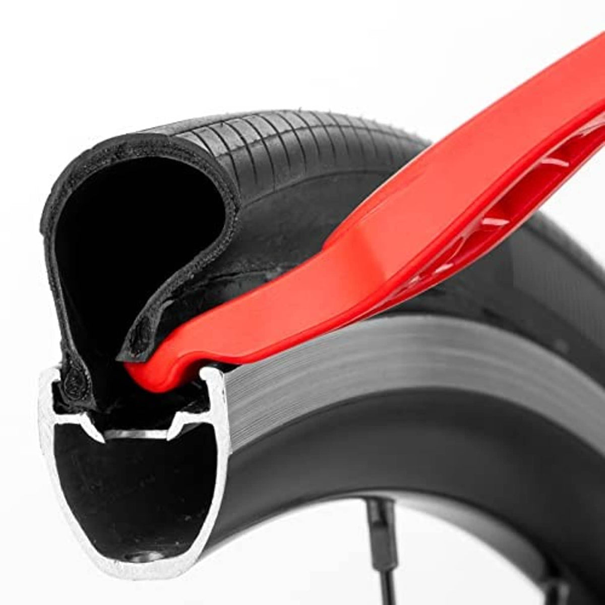 Close-up of red lever prying a black bicycle tire from the rim