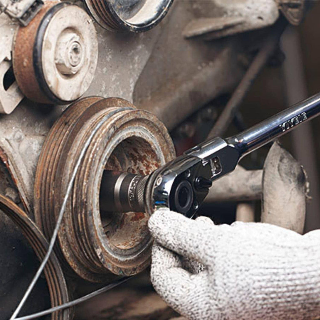 Flex-head ratchet wrench gripping engine fastener with gloved hand