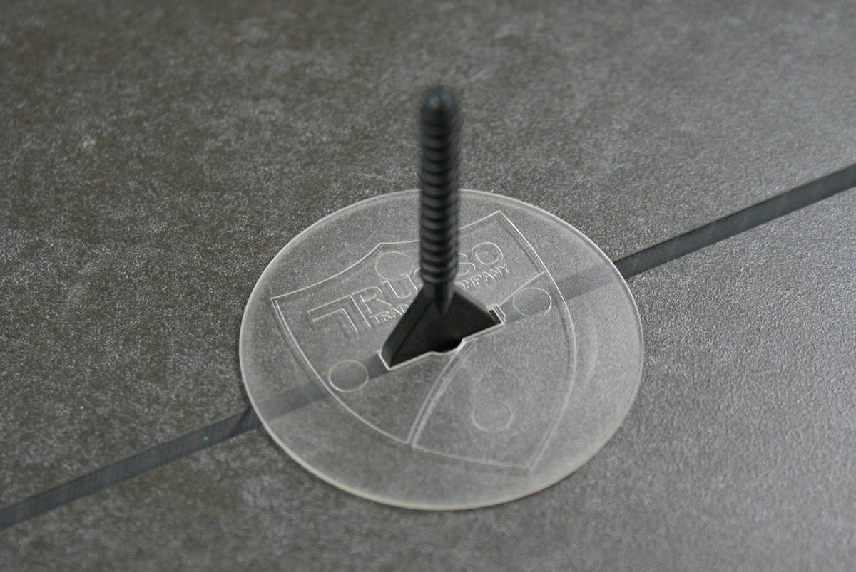 Tile leveling system black baseplate with circular disc on tile joint