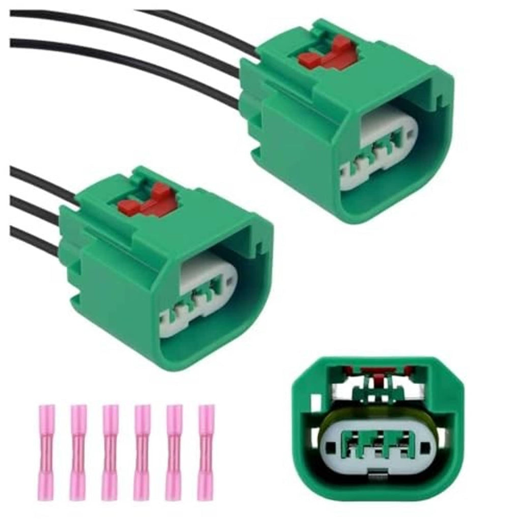 Pair of green headlight connector plugs with terminals and black wire leads