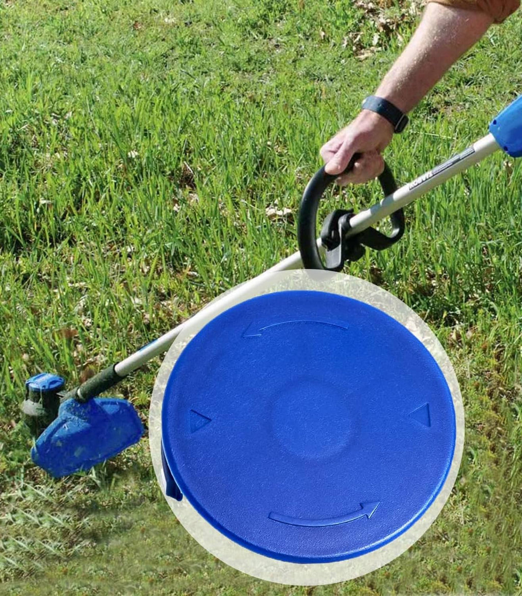 Blue spool cap cover on string trimmer head while edging grass