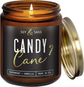 Amber glass candle jar with open flame and black “Candy Cane” label, soy & sass branding