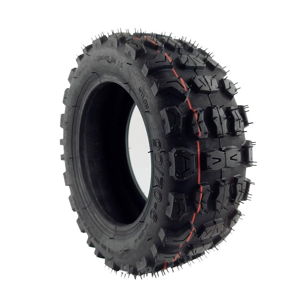 Off-road tire side view with black tread, red accents, and studded traction lugs