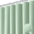 Mint green waffle-weave shower curtain with round grommets, multiple hanging panels on a rod