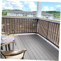 Brown woven privacy screen fabric mounted to a balcony railing