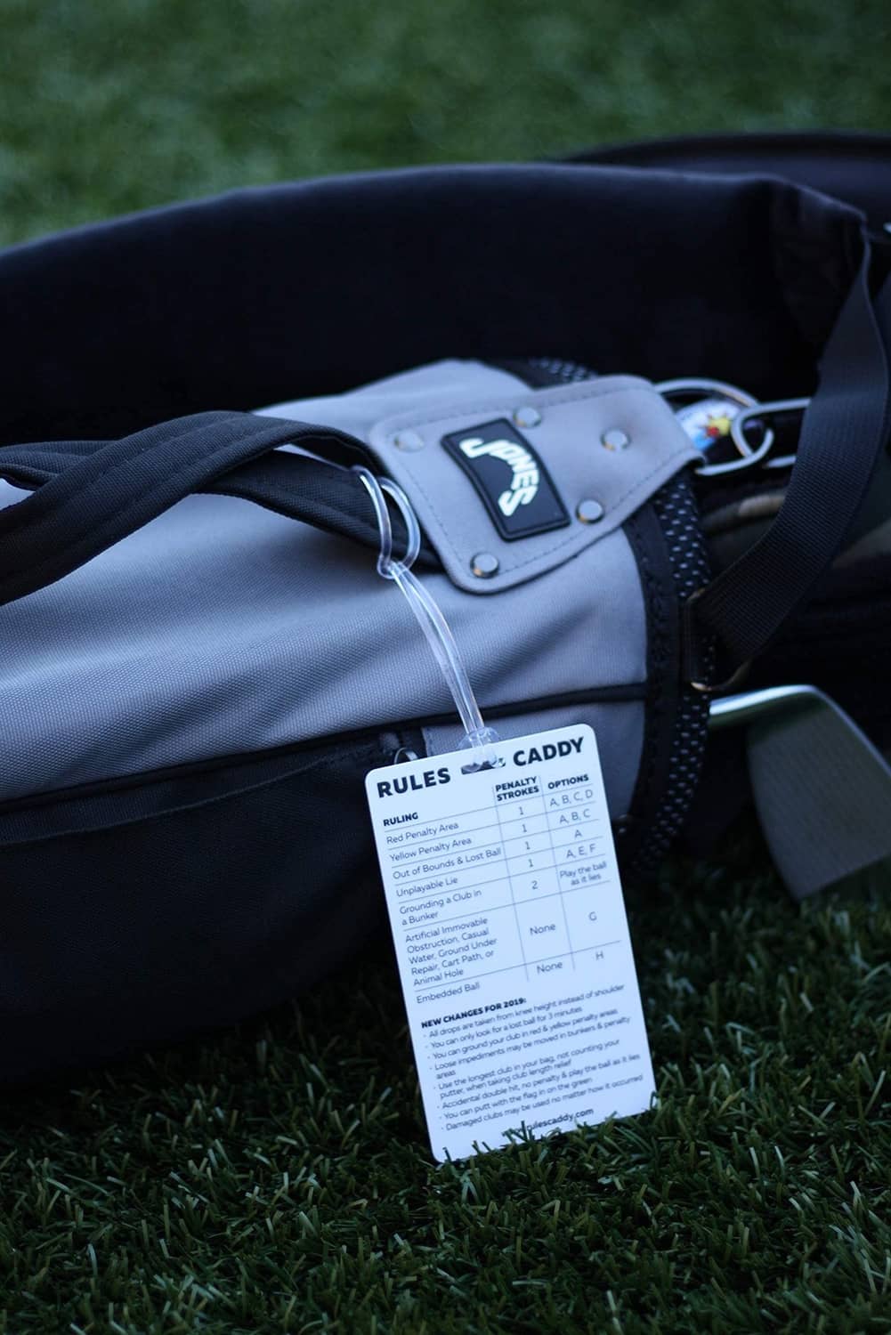 Rules Caddy quick reference card hanging from dark golf bag strap
