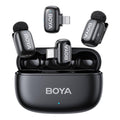 BOYA wireless microphone charging case with two black clip-on mics and foam windscreens