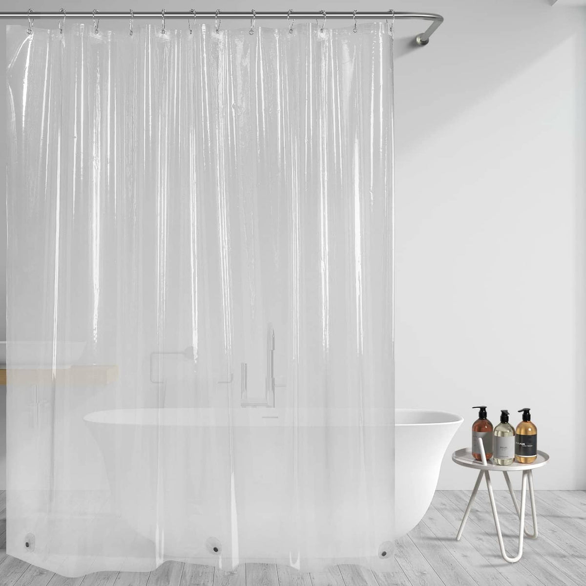 Clear shower curtain liner hanging in front of tub, see-through coverage