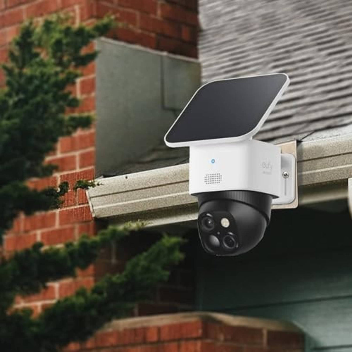 Stainless steel gutter camera mount bracket holding a dome security camera under eave