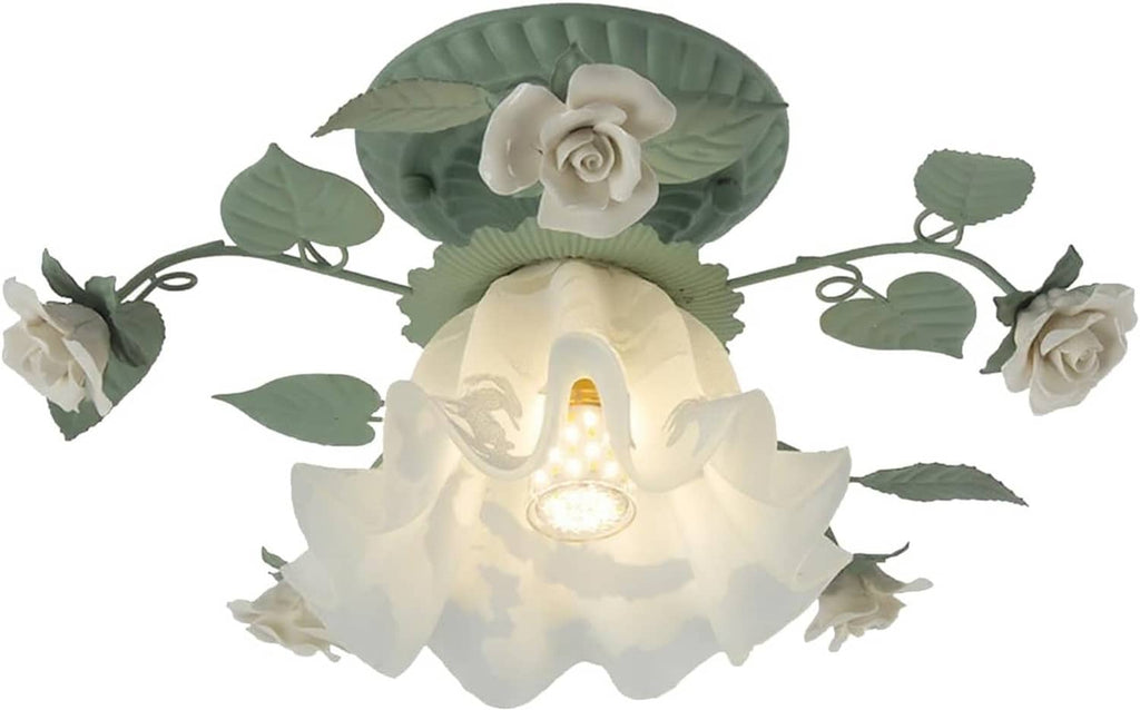 Flower ceiling light fixture with green leaf metal scrollwork and white glass blossoms, lit bulb