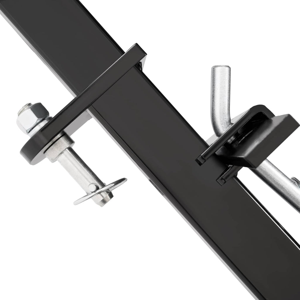 Close-up of hitch pins and black scraper blade support bar with clevis hardware