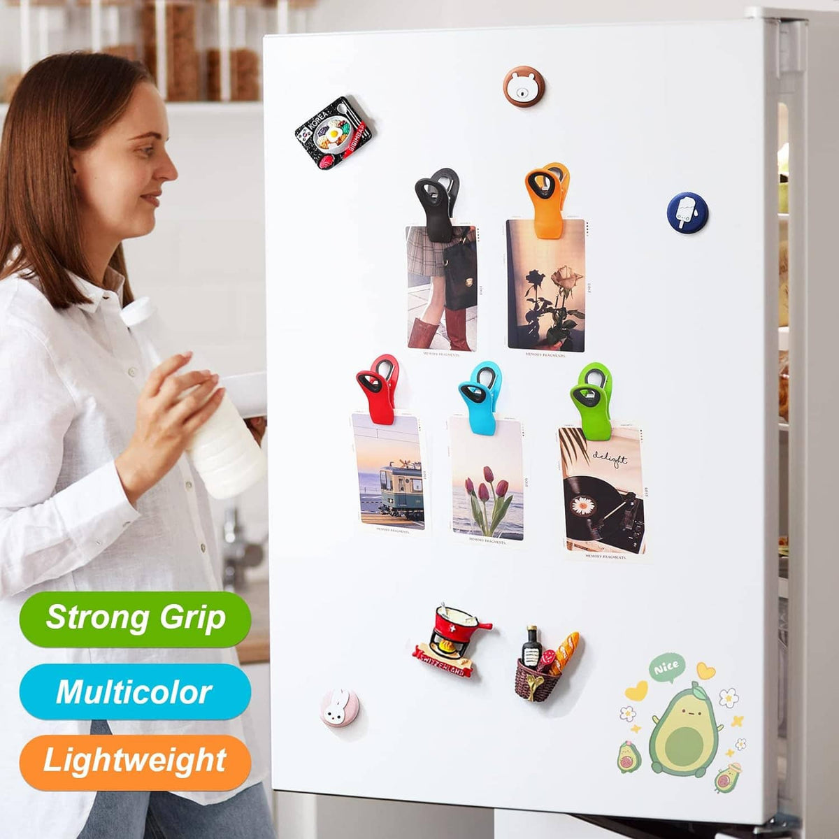 Colorful magnetic clips holding photos on a white refrigerator door
