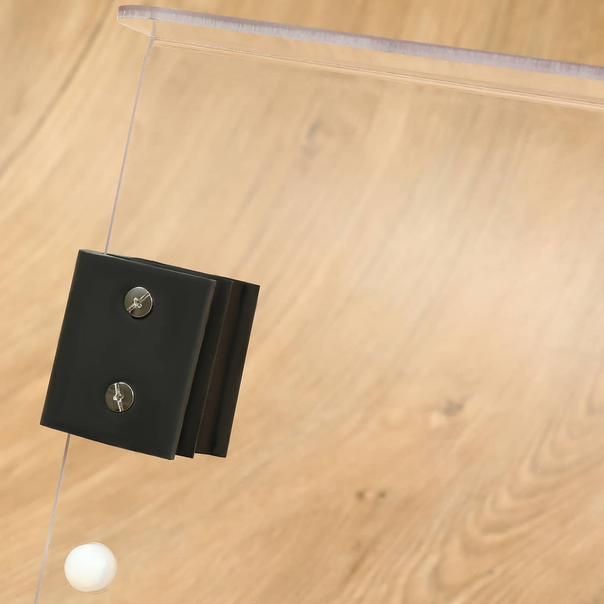 Clear windshield panel with black side mounting blocks and fasteners