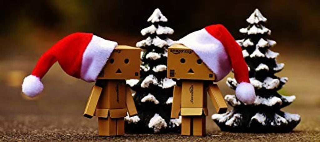 Red mini Santa hats with white trim and pom-poms on small figures