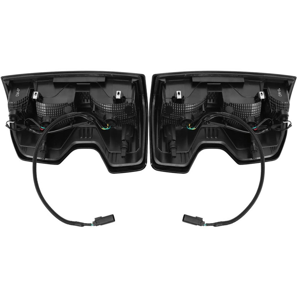 Back view of two black tail light housings with wiring harness and plug ends