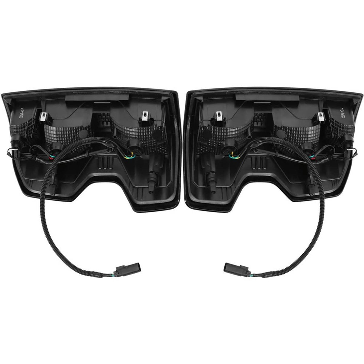 Back view of two black tail light housings with wiring harness and plug ends