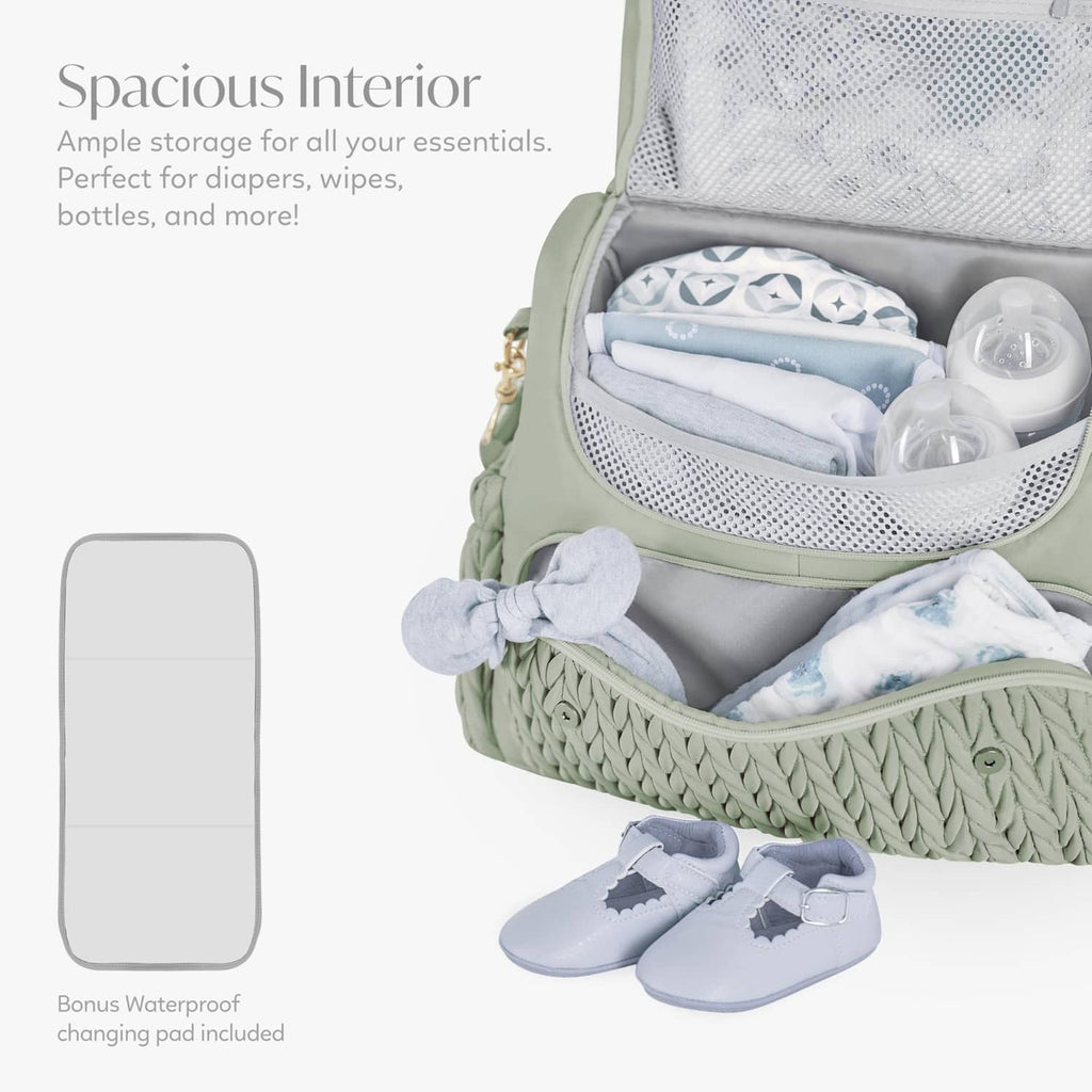 Sage green convertible diaper backpack opened, showing interior pockets and changing pad