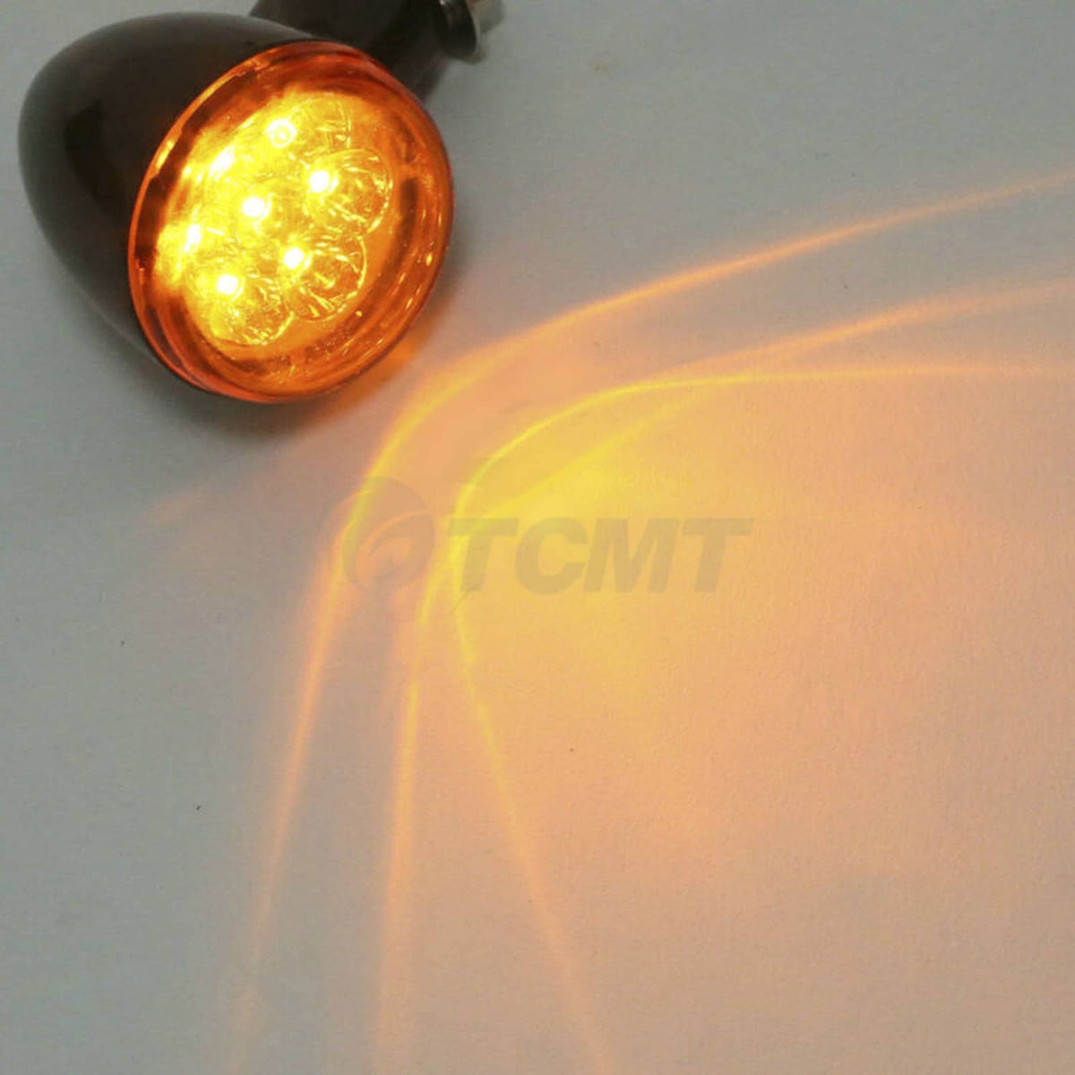 Rear LED turn signal light with amber lens on a black mount, close-up view