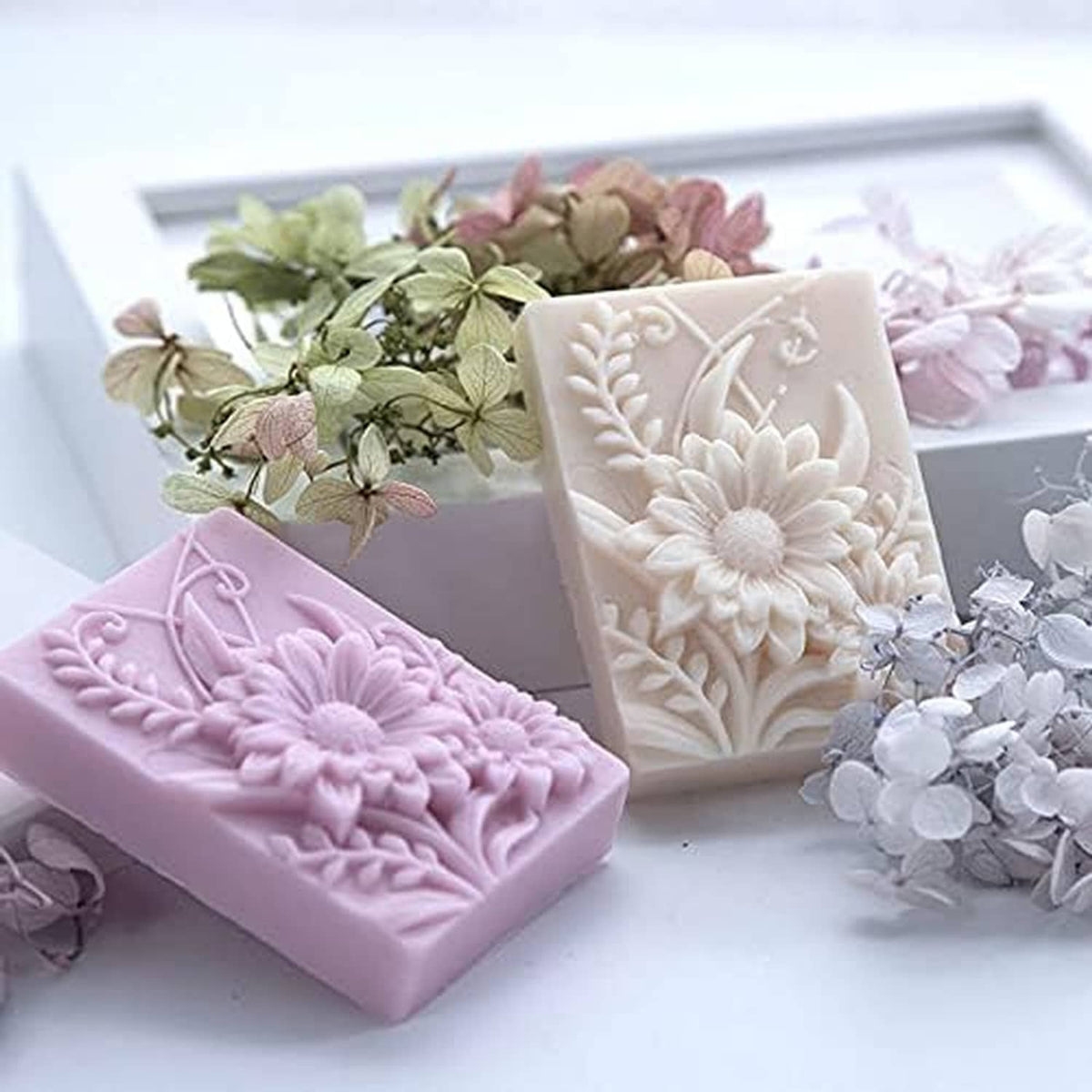 Flower-embossed soap bars in pink, white, and lavender with relief petal designs