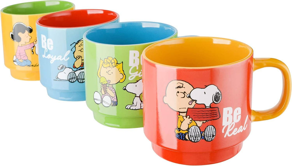 Set of four Snoopy stoneware mugs with colorful Be artwork, front views.